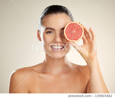 Skincare, beauty and woman portrait with grapefruit for natural skin dermatology or cosmetics. Vitamin c fruit on happy face aesthetic model in studio for sustainable health and wellness self care Skincare, beauty and woman portrait with grapefruit for natural skin dermatology or cosmetics. Vitamin c fruit on happy face aesthetic model in studio for sustainable health and wellness self care 130603882
