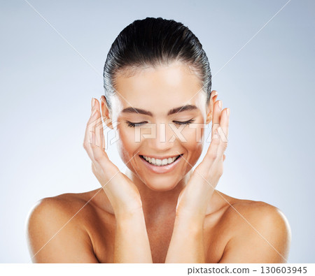Happy, health and skincare of natural woman with smile for hydration, self care and glow aesthetic of people. Dermatology, beauty and healthy skin of person on isolated gray studio background Happy, health and skincare of natural woman with smile for hydration, self care and glow aesthetic of people. Dermatology, beauty and healthy skin of person on isolated gray studio background 130603945
