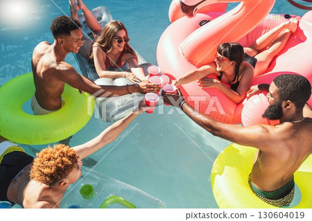 Toast, drinks and friends at a pool party for celebration, holiday and swimming in Los Angeles. Water, happy and group of people with a cheers, alcohol and champagne on a hotel vacation in summer Toast, drinks and friends at a pool party for celebration, holiday and swimming in Los Angeles. Water, happy and group of people with a cheers, alcohol and champagne on a hotel vacation in summer 130604019