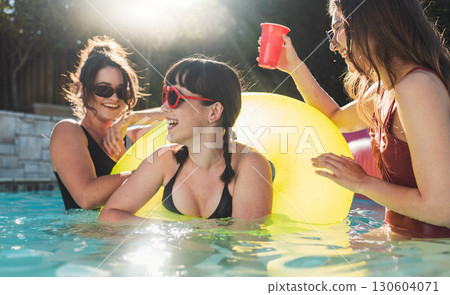 Friends, women and pool party, summer and fun for holiday, break and bonding together, playful smile and weekend. Young people, girl or females in water, event and celebration on vacation and playful Friends, women and pool party, summer and fun for holiday, break and bonding together, playful smile and weekend. Young people, girl or females in water, event and celebration on vacation and playful 130604071