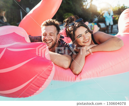 Pool party, portrait and happy couple floating in the water together while on vacation at a resort. Float, summer and young man and woman in a swimming pool having fun on a holiday or weekend trip. Pool party, portrait and happy couple floating in the water together while on vacation at a resort. Float, summer and young man and woman in a swimming pool having fun on a holiday or weekend trip. 130604078