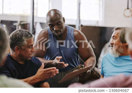 Personal trainer, gym checklist and black man talking to senior clients for training progress, coaching advice or membership paper. Fitness with workout or exercise schedule, wellness and sports club Personal trainer, gym checklist and black man talking to senior clients for training progress, coaching advice or membership paper. Fitness with workout or exercise schedule, wellness and sports club 130604087