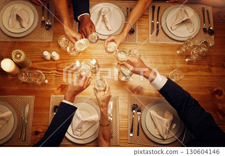 Champagne, glasses and cheers for celebration at a dinner for festive, new years eve or birthday. Party, event and top view of wine for a celebrating toast by a dining table at a restaurant or home. Champagne, glasses and cheers for celebration at a dinner for festive, new years eve or birthday. Party, event and top view of wine for a celebrating toast by a dining table at a restaurant or home. 130604146