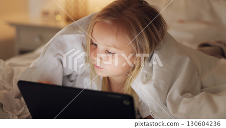 Girl child, tablet and bedroom in night, reading or app to watch video, movie and relax with blanket in family home. Female kid, digital touchscreen and bed for cartoon, games or learning in house 130604236