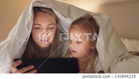Bed, mother and girl with tablet, blanket fort and connection with social media, streaming movie and bonding. Family, mama and kid with technology, bedroom and home with digital app, games and relax 130604238