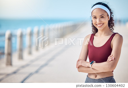 Happy woman, portrait and fitness with arms crossed at beach promenade for exercise, wellness and mockup in Miami. Female athlete, smile and standing at seaside for workout, summer training or sports 130604402