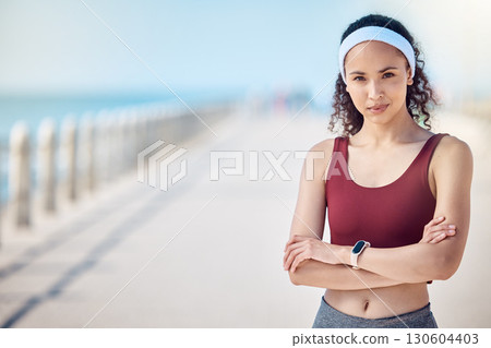 Fitness, portrait and woman with arms crossed at beach promenade for exercise, wellness and mockup in Miami. Female sports athlete standing at seaside outdoor for workout, summer training and running 130604403