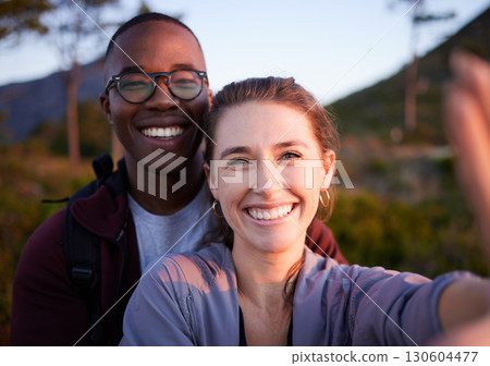 Nature, selfie and portrait of interracial couple on mountain for holiday, vacation and hiking adventure on weekend. Travel, wellness and happy man with woman enjoy calm, freedom and peace at sunset 130604477