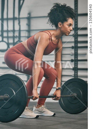 Gym, barbell exercise and black woman doing muscle fitness performance for body health, strength training or bodybuilding. Arm workout, athlete wellness lifestyle and strong bodybuilder weightlifting 130604540