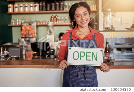Small business, portrait or black woman with an open sign to welcome sales in cafe or coffee shop. Marketing, female manager or happy entrepreneur smiles while advertising or opening a retail store 130604550