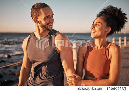 Black couple, fitness and walking at the beach with smile for conversation, talk or sunset together in the outdoors. Happy man and woman enjoying fun walk smiling for holiday break by the ocean coast Black couple, fitness and walking at the beach with smile for conversation, talk or sunset together in the outdoors. Happy man and woman enjoying fun walk smiling for holiday break by the ocean coast 130604585