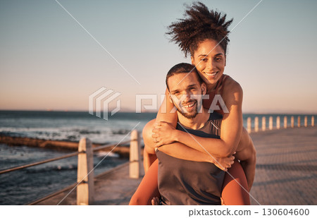 Fitness, beach and portrait of couple piggyback enjoy holiday, vacation and quality time on weekend. Love, summer and black man and woman relax after running, exercise workout and training by ocean 130604600