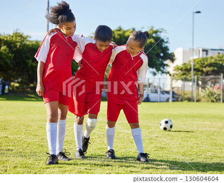 Soccer, injury and children team help, support and walk with hurt friend during game at a sports field. Sport, accident and kids football group helping girl player after fitness, training and match 130604604