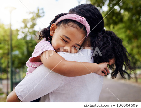 Hug, park and mother and daughter, love and sweet while bonding outdoor together. Black woman, embrace and fun in a forest, precious and happy, content and relax in a beautiful moment of motherhood 130604609