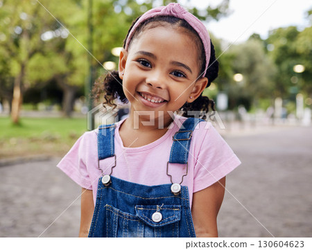 Portrait, young girl and smile in park, happy child outdoor with nature and freedom with positive mindset. Travel, happiness and adventure, growth and childhood with family day out and youth mockup 130604623