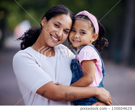 Portrait, mother and kid hug in park, fun day outdoor with love and care, happy people together in nature. Family, happiness and bonding with childhood, woman and girl are content with smile 130604629