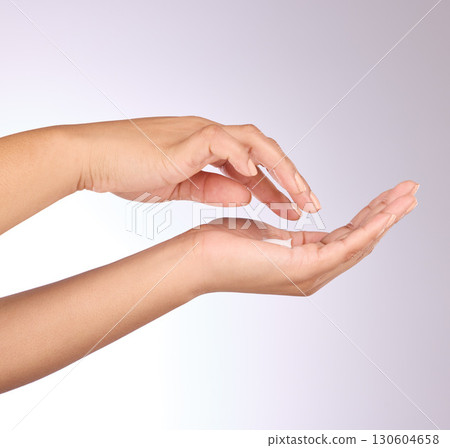 Hands, lotion and beauty, skincare and woman, manicure and nail polish with cosmetics on studio background. Sunscreen, moisturizer application and dermatology with cream cosmetic product and female Hands, lotion and beauty, skincare and woman, manicure and nail polish with cosmetics on studio background. Sunscreen, moisturizer application and dermatology with cream cosmetic product and female 130604658