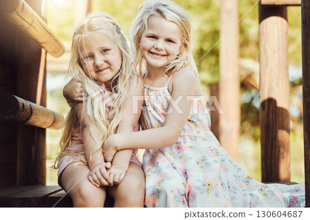 Portrait, children and girl siblings outdoor together at a park during summer vacation or holiday. Family, kids and love with a female child and sister hugging while bonding outside or having fun 130604687
