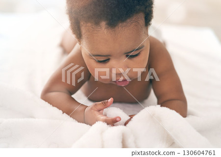 Black girl, blanket and kids with a baby in a home, lying on the floor for growth or child development. Relax, children and family home with a newborn infant playing in the living room of a house 130604761