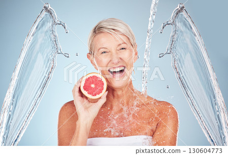 Woman, grapefruit and studio portrait with water splash, happiness and cosmetics for wellness by blue background. Senior model, citrus fruit and vitamin c for health, nutrition and self care process Woman, grapefruit and studio portrait with water splash, happiness and cosmetics for wellness by blue background. Senior model, citrus fruit and vitamin c for health, nutrition and self care process 130604773