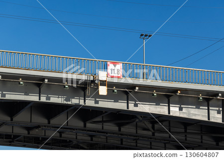 Overpass metal road bridge with and vessel height limitation sign. Saint-Petersburg 130604807