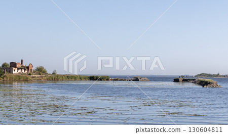 Coastal panoramic view with ruins of historical buildings under clear blue sky 130604811
