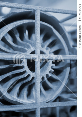 Object printed on 3D printer from molten plastic powder close-up. Model printed on 3D printer from melted polyamide powder. New modern additive 3D printing technology. Multi Jet Fusion MJF technology Object printed on 3D printer from molten plastic powder close-up. Model printed on 3D printer from melted polyamide powder. New modern additive 3D printing technology. Multi Jet Fusion MJF technology 130605094