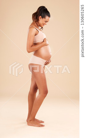 Pregnancy profile, lingerie and studio woman with smile, happy and excited for baby, stomach growth or motherhood. Gynecology care, maternity wellness or pregnant model with healthcare, love and hope 130605265