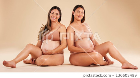Women, portrait or sitting with pregnant stomach, tummy growth progress or baby healthcare wellness on studio background. Smile, happy or friends in pregnancy underwear for solidarity support or love Women, portrait or sitting with pregnant stomach, tummy growth progress or baby healthcare wellness on studio background. Smile, happy or friends in pregnancy underwear for solidarity support or love 130605489