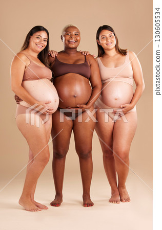 Pregnant, body and portrait of women in stomach support touch, hope and community diversity on studio background. Smile, happy and pregnancy friends in underwear, belly growth and healthcare wellness Pregnant, body and portrait of women in stomach support touch, hope and community diversity on studio background. Smile, happy and pregnancy friends in underwear, belly growth and healthcare wellness 130605534