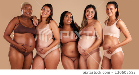 Pregnancy body, portrait and bonding women on studio background in diversity empowerment, baby support and community. Smile, happy and pregnant friends in underwear with stomach growth, touch or love Pregnancy body, portrait and bonding women on studio background in diversity empowerment, baby support and community. Smile, happy and pregnant friends in underwear with stomach growth, touch or love 130605552