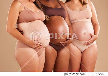Pregnant, body and holding stomach in support line, solidarity and community diversity on studio background. Pregnancy friends, women and underwear in belly growth, healthcare wellness or mothers day Pregnant, body and holding stomach in support line, solidarity and community diversity on studio background. Pregnancy friends, women and underwear in belly growth, healthcare wellness or mothers day 130605566