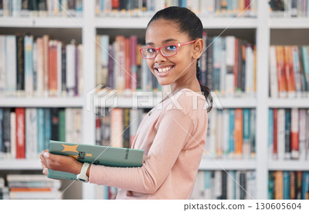 Books, education or girl reading in library for knowledge or development for future growth. Scholarship, portrait or school student with a happy smile studying or learning information in a fun story Books, education or girl reading in library for knowledge or development for future growth. Scholarship, portrait or school student with a happy smile studying or learning information in a fun story 130605604