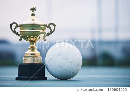 Gold, winner and sports with trophy and netball for achievement, award and championship. Celebration, fitness and victory with prize and ball on ground of court for event, competition and success Gold, winner and sports with trophy and netball for achievement, award and championship. Celebration, fitness and victory with prize and ball on ground of court for event, competition and success 130605913