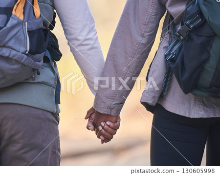 Holding hands, couple outdoor hiking with support and trust, fitness and adventure with commitment. Travel, exercise and people together in nature, health and wellness with partnership back view Holding hands, couple outdoor hiking with support and trust, fitness and adventure with commitment. Travel, exercise and people together in nature, health and wellness with partnership back view 130605998