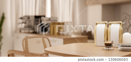 A wooden table with coffee bean bag with blurred view of coffee machines in kitchen or break room. 130606083