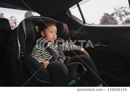 toddler girl sitting in car seat, safety baby chair travelling 130606156