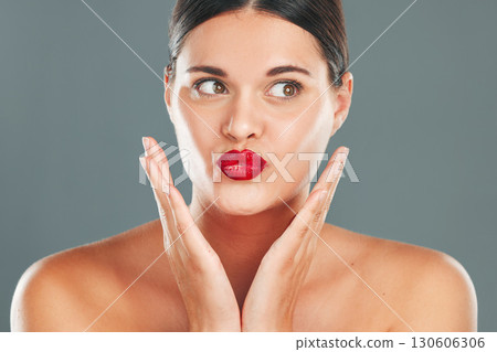 Woman lips with lipstick, kiss face and makeup with red cosmetics and playful pout isolated on studio background. Healthy skin, beauty and skincare with cosmetic care, wellness and facial glow Woman lips with lipstick, kiss face and makeup with red cosmetics and playful pout isolated on studio background. Healthy skin, beauty and skincare with cosmetic care, wellness and facial glow 130606306