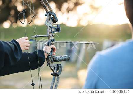 Archery, closeup and target training with an instructor on field for hobby, aim and control. Arrow, practice and archer people together outdoor for hunting, precision and weapon, shooting competition Archery, closeup and target training with an instructor on field for hobby, aim and control. Arrow, practice and archer people together outdoor for hunting, precision and weapon, shooting competition 130606395