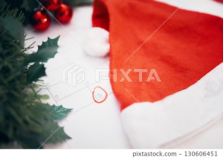 Christmas, preparation and calendar with decorations for the holiday, planning and celebration of an event. Hat, festive and a planner with an important date for xmas, countdown and tradition 130606451