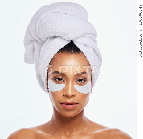 Beauty patch, eye skincare and woman portrait in studio for natural dermatology. Aesthetic model for spa facial, towel and healthy or clean face glow cosmetic product isolated on a white background 130606545