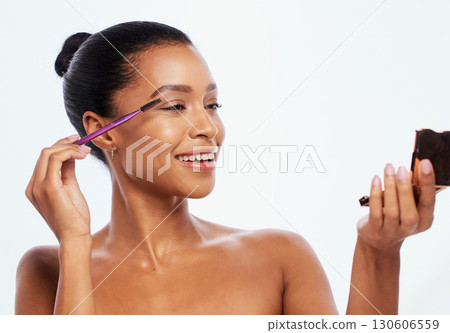 Makeup, beauty and woman with eyebrow brush and mirror using cosmetic product isolated in studio white background. Face, dermatology and model with elegant and smooth skin as self care routine Makeup, beauty and woman with eyebrow brush and mirror using cosmetic product isolated in studio white background. Face, dermatology and model with elegant and smooth skin as self care routine 130606559