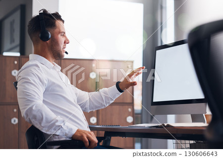 Man, call center and consulting on computer mockup for telemarketing, advertising or customer support at office. Male consultant explaining digital marketing or web service in desktop communication Man, call center and consulting on computer mockup for telemarketing, advertising or customer support at office. Male consultant explaining digital marketing or web service in desktop communication 130606643