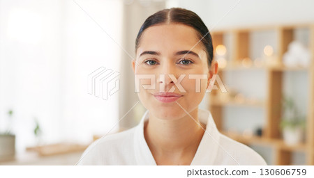 Face, portrait and woman at spa for skincare, luxury massage and wellness on a bed at a hotel. Happy, smile and beauty of a young girl at a salon to relax for peace and calm during cosmetic therapy 130606759