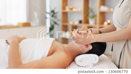 Wellness, spa and woman with facial massage, beauty and peace with stress relief, beautician or relax. Person laying on a tablet, client and girl with luxury, calm or skincare with vacation or resort 130606770