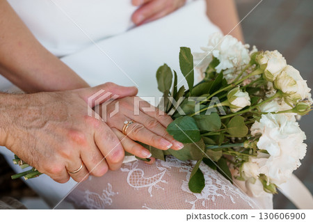 Wedding Rings Exchange, Hands Holding Bouquet, White Roses, Lace Dress, Romantic Love, Golden Bands, Celebration, Unity, Soft Focus Photography Wedding Rings Exchange, Hands Holding Bouquet, White Roses, Lace Dress, Romantic Love, Golden Bands, Celebration, Unity, Soft Focus Photography 130606900