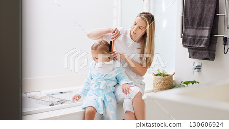 Hair care, mother and girl in bathroom, with brush and bonding to connect, talking and for fun. Female, lady and daughter or kid doing development, child growth and discussion together at home loving 130606924