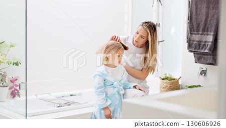 Morning, mother and daughter in bathroom with hair brush for grooming care routine in family home. Motherhood, child and mama brushing hair of young kid in house and getting ready for the day. Morning, mother and daughter in bathroom with hair brush for grooming care routine in family home. Motherhood, child and mama brushing hair of young kid in house and getting ready for the day. 130606926