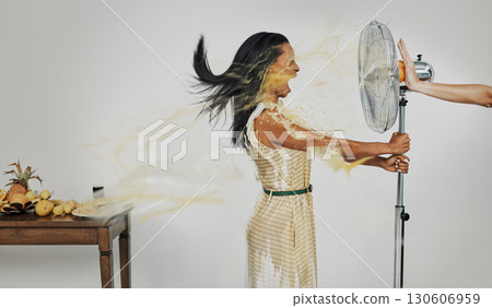 Art, juice and summer splash, woman with refreshing wind in face from fan and fruit for cocktail drinks. Air con, heat and fresh squeezed orange spray blowing with scream in creative advertisement. 130606959