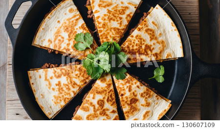 Beef Quesadilla Slices in Cast Iron Pan with Cilantro Beef Quesadilla Slices in Cast Iron Pan with Cilantro 130607109